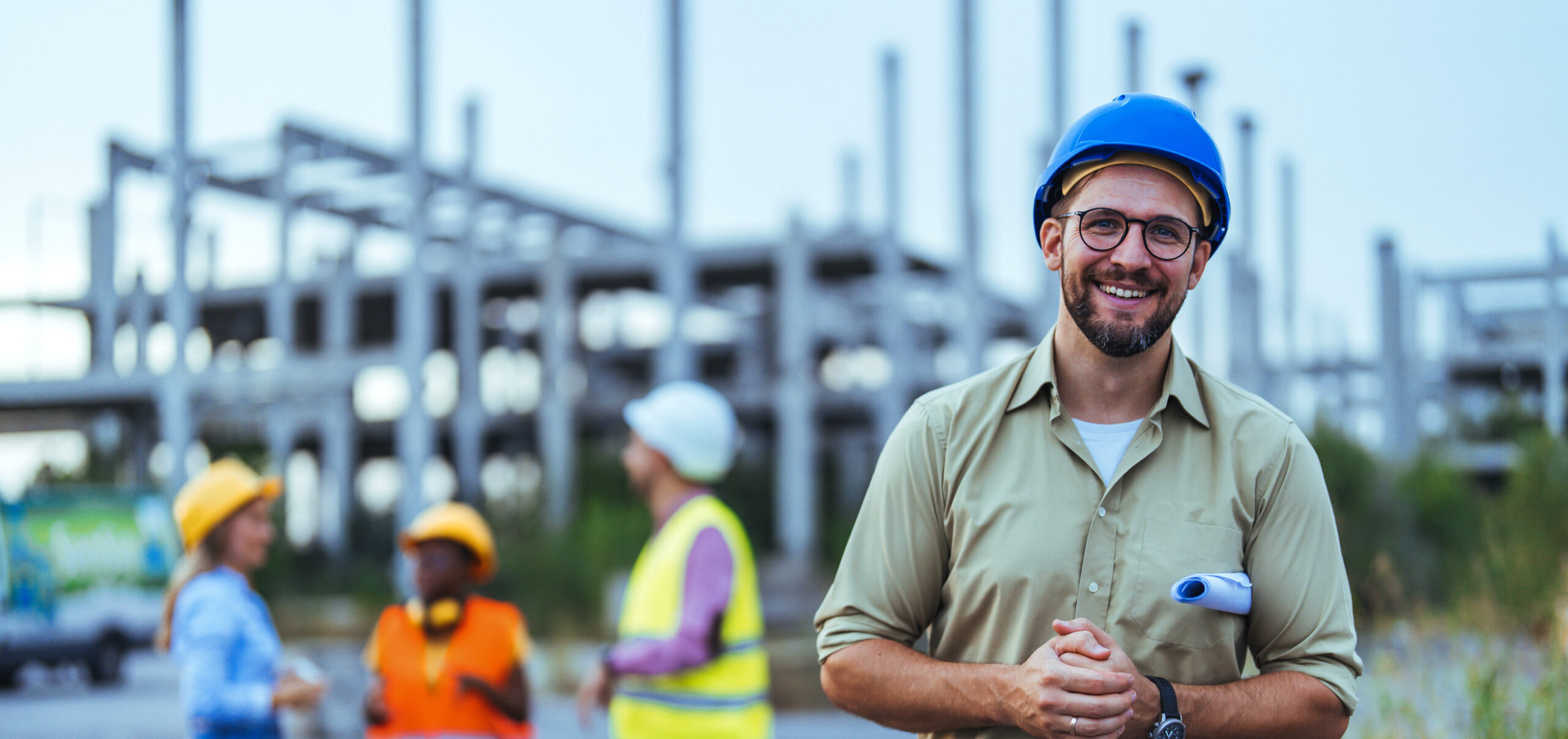 Confident Construction Worker Smiling at Building Site